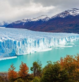 surreal blue water and glacier with a mountain backdrop