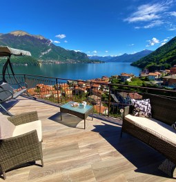 Chairs on the balcony overlooking the village, lake, and mountains