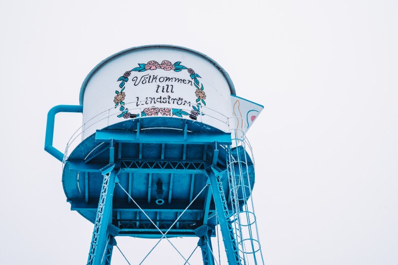 Famous teapot shaped watertower reads 'Welcome to Lindstrom' translated from Swedish