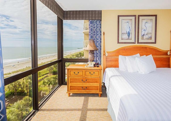 Hotel room with big panoramic windows and an ocean view