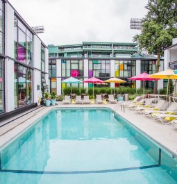 hotel pool with loungers and colorful umbrellas